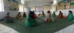 Community Health workers learning yoga practices to bring back and implement in their villages 